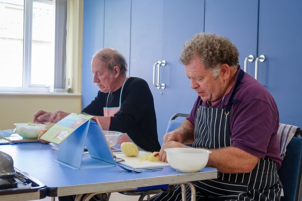Two gentlemen getting practical experience of cooking during the Preparing a Healthy Meal course during the first cohort in May.
